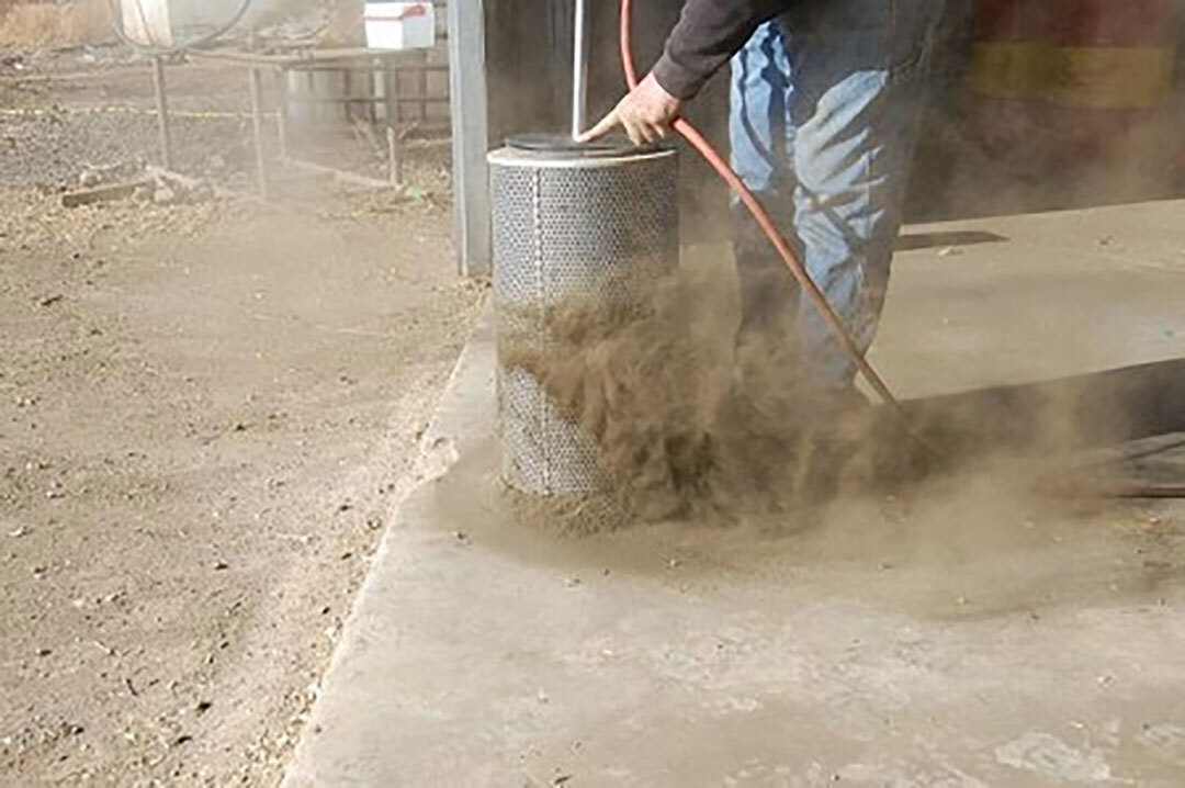 Air Filter Blaster Portable Unit cleaning a diesel air filter with compressed air.